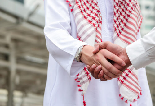 Arab businessman handshake with partner outdoor. Greeting. Business agreement.