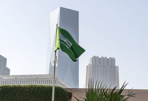 flag of Saudi Arabia against the background of tall building,